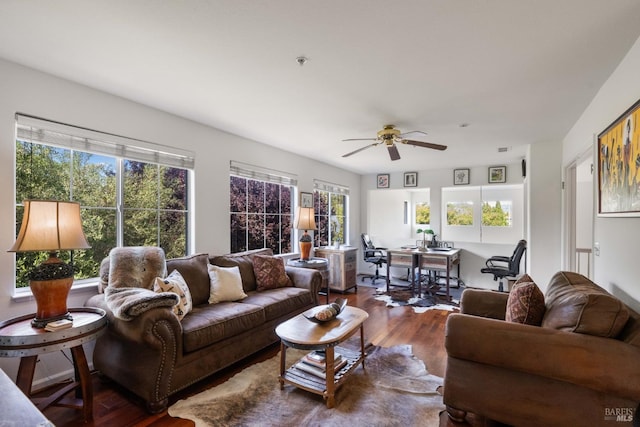living area with a ceiling fan and wood finished floors