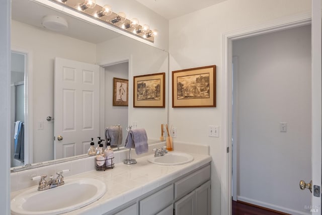 full bath with a sink and double vanity