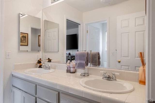 bathroom with double vanity and a sink