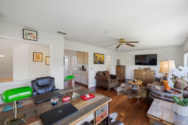 living area with ceiling fan, wood finished floors, and visible vents