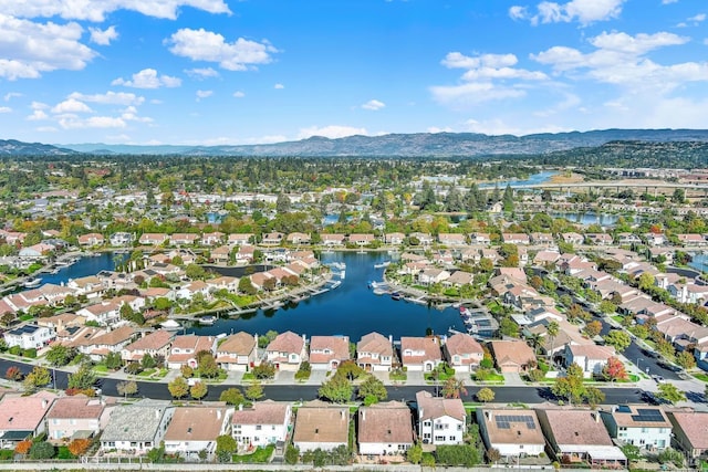 birds eye view of property with a water and mountain view and a residential view