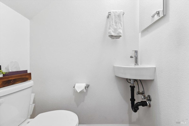 bathroom featuring toilet and a sink