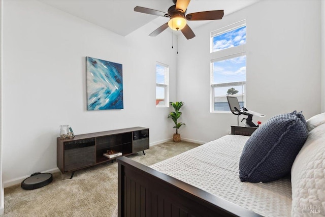bedroom with baseboards, light carpet, and a ceiling fan
