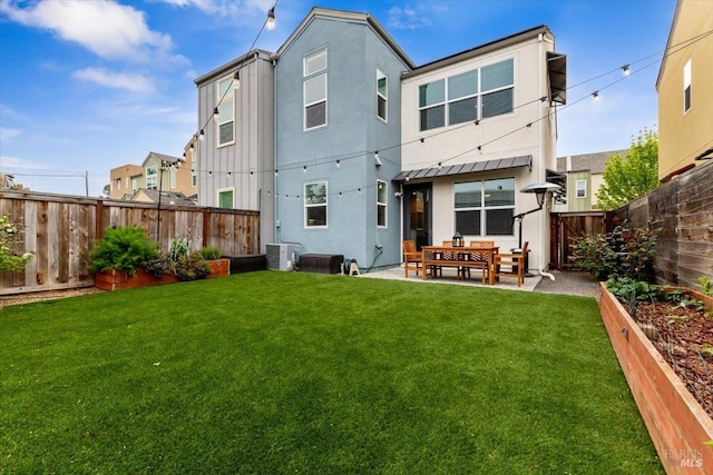 back of house with a fenced backyard, stucco siding, a standing seam roof, a patio area, and a yard