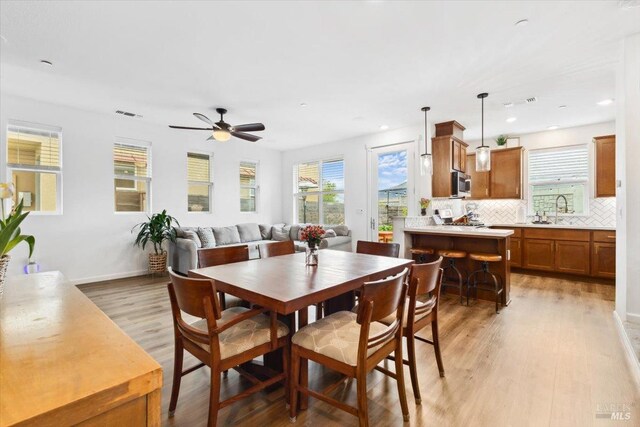 dining space featuring recessed lighting, a ceiling fan, light wood finished floors, and a wealth of natural light