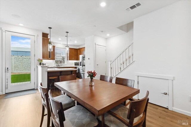 dining area featuring visible vents, stairs, baseboards, light wood finished floors, and recessed lighting