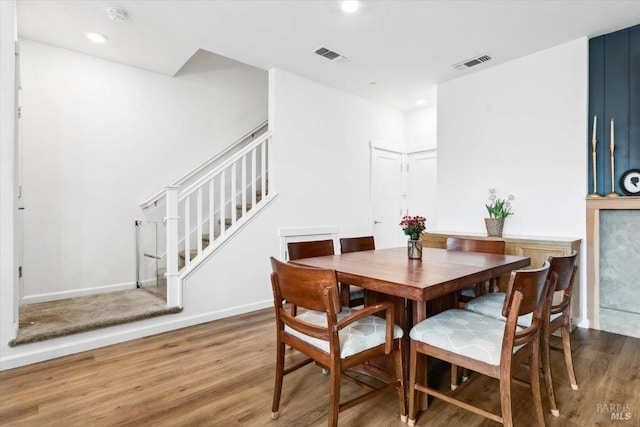 dining room with recessed lighting, stairs, wood finished floors, and visible vents