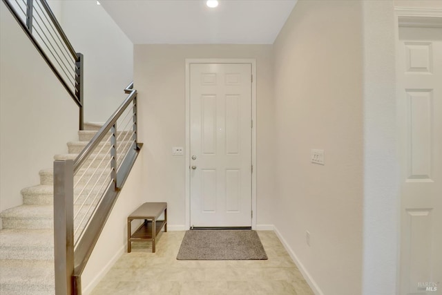 entrance foyer featuring recessed lighting, baseboards, and stairs