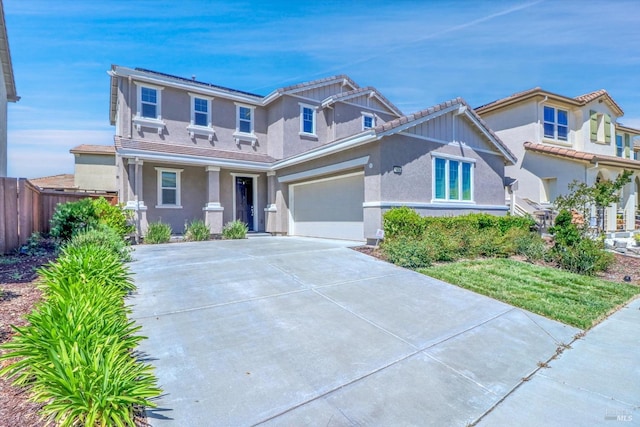 craftsman inspired home with fence, an attached garage, stucco siding, and concrete driveway