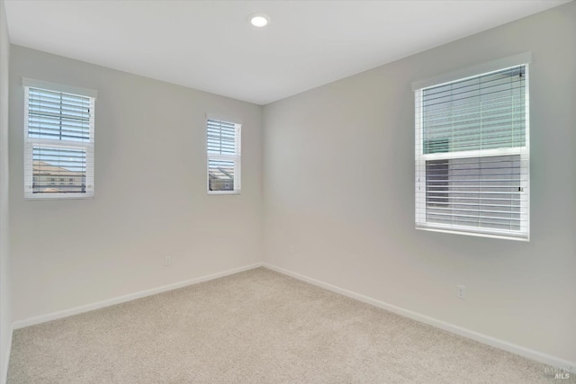 empty room with recessed lighting, baseboards, and carpet