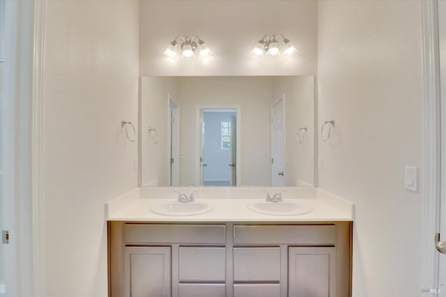 full bathroom featuring double vanity and a sink