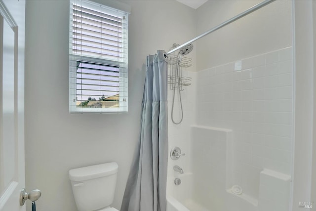 full bathroom featuring toilet and shower / tub combo with curtain