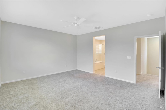 unfurnished bedroom with baseboards, carpet flooring, ensuite bath, and visible vents