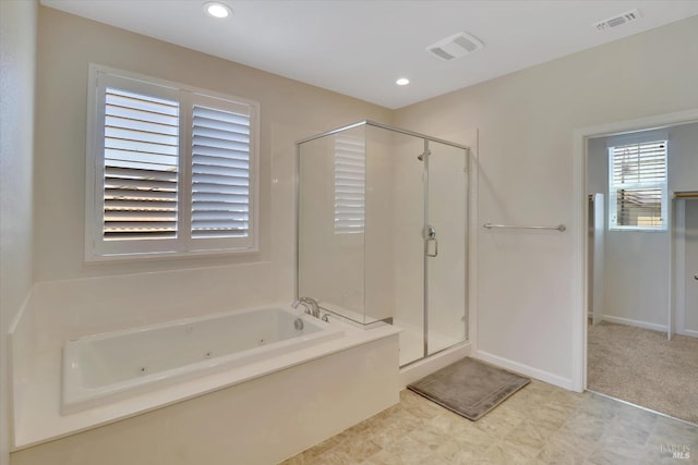bathroom featuring a jetted tub, a stall shower, and visible vents