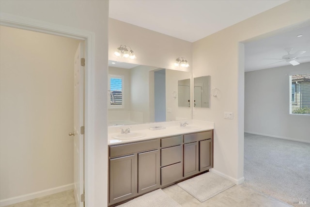 full bathroom with a sink, baseboards, and a wealth of natural light