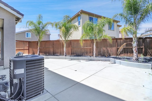 view of patio / terrace featuring cooling unit and a fenced backyard