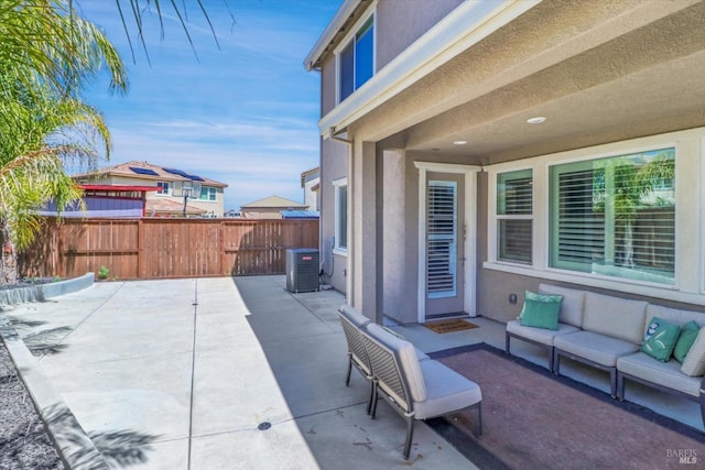 view of patio / terrace with outdoor lounge area, central AC unit, and fence private yard