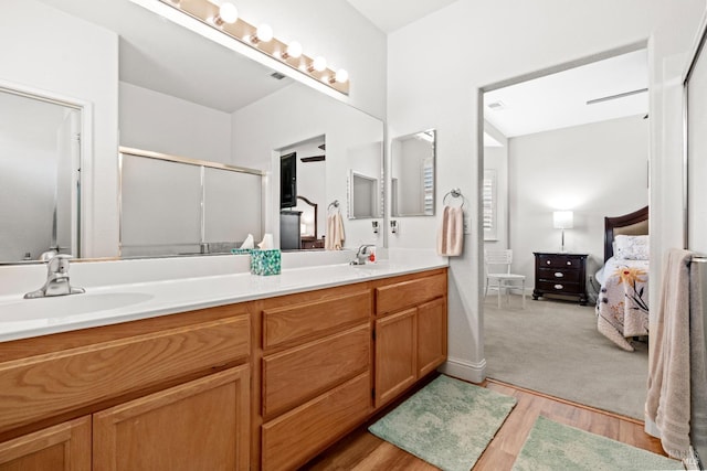 811 Inverness Dr, Rio Vista, CA 94571 - ensuite bathroom featuring double vanity, wood finished floors, ensuite bathroom, a sink, and a shower with shower door