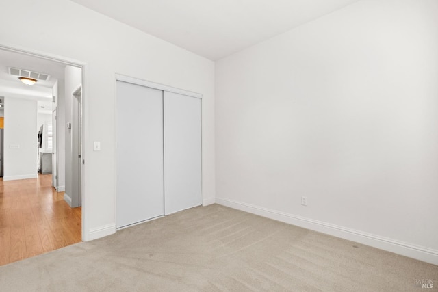 811 Inverness Dr, Rio Vista, CA 94571 - unfurnished bedroom with visible vents, baseboards, a closet, and light colored carpet