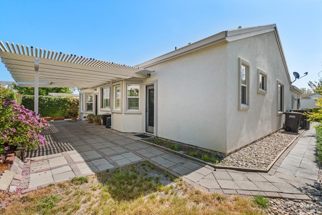 811 Inverness Dr, Rio Vista, CA 94571 - rear view of house with a patio, central air condition unit, stucco siding, and a pergola