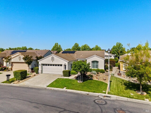 811 Inverness Dr, Rio Vista, CA 94571 - ranch-style home with a garage, stucco siding, roof mounted solar panels, concrete driveway, and a tile roof