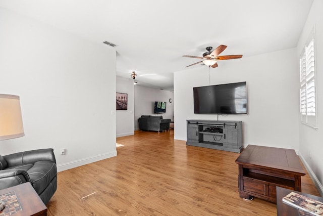 811 Inverness Dr, Rio Vista, CA 94571 - living room featuring baseboards, ceiling fan, visible vents, and light wood-style flooring