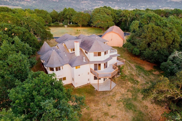 birds eye view of property with a view of trees