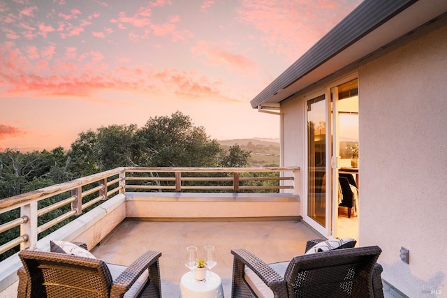 balcony at dusk with a mountain view