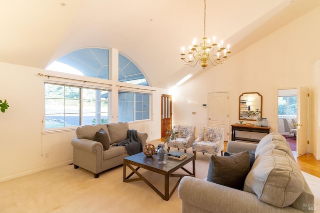 living area with baseboards, a notable chandelier, and high vaulted ceiling