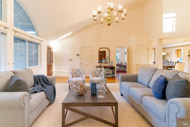 living area with an inviting chandelier and high vaulted ceiling