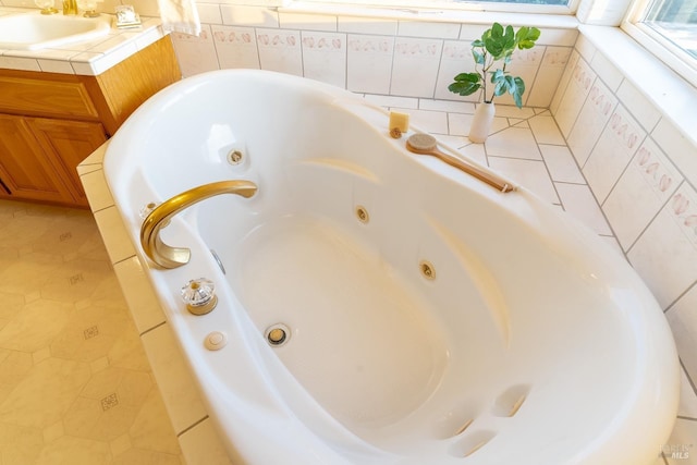 bathroom featuring a jetted tub and vanity