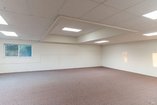 spare room with carpet and a paneled ceiling