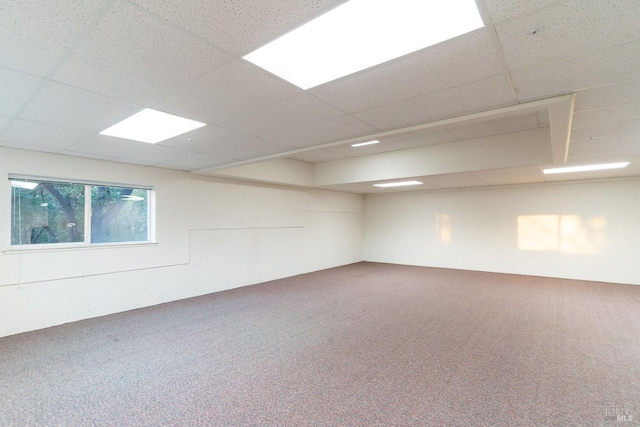 spare room with carpet floors and a drop ceiling