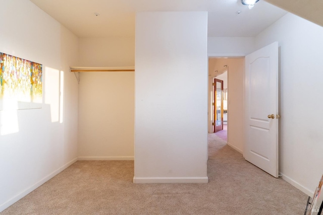 unfurnished bedroom featuring carpet flooring, baseboards, and multiple windows