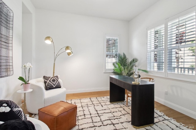 office area with baseboards and wood finished floors