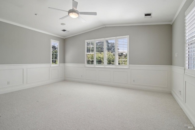 empty room featuring plenty of natural light, visible vents, and light colored carpet
