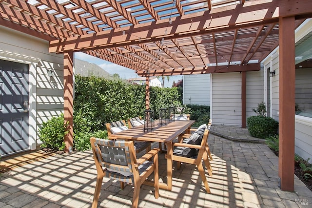 view of patio featuring a pergola and outdoor dining area