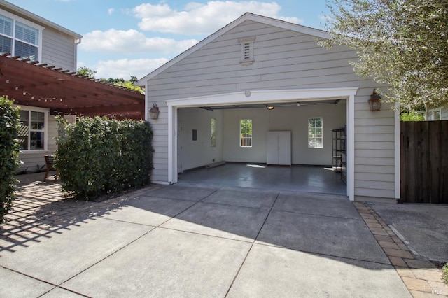 garage with fence and driveway