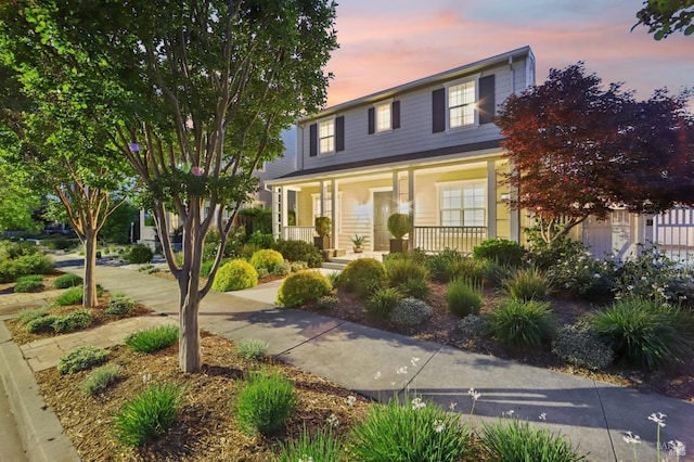 traditional-style home featuring covered porch