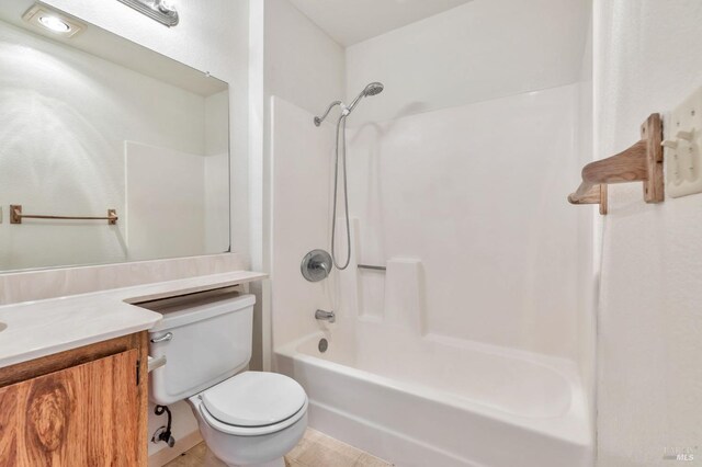 full bathroom featuring toilet, tub / shower combination, and vanity