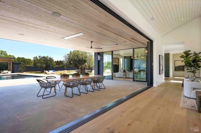 view of patio with a ceiling fan and an outdoor pool