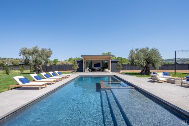 view of swimming pool featuring an outdoor structure, a patio, a fenced backyard, and an outdoor living space with a fire pit