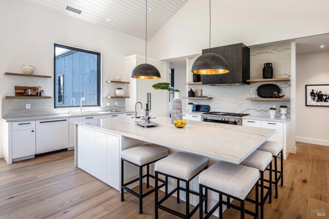 kitchen featuring white cabinetry, open shelves, extractor fan, and a sink