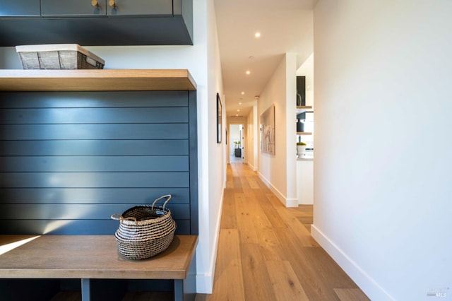 hallway with light wood-type flooring, recessed lighting, and baseboards