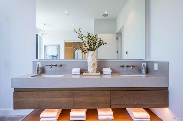 full bath with a sink and double vanity