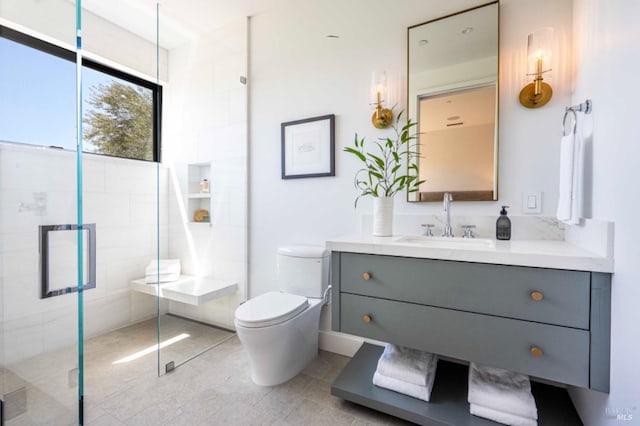 bathroom with toilet, a shower stall, tile patterned flooring, and vanity