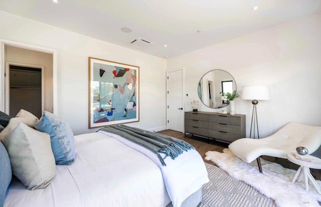 bedroom with recessed lighting and wood finished floors