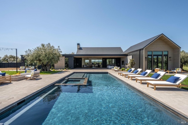 view of pool with a patio and a pool with connected hot tub