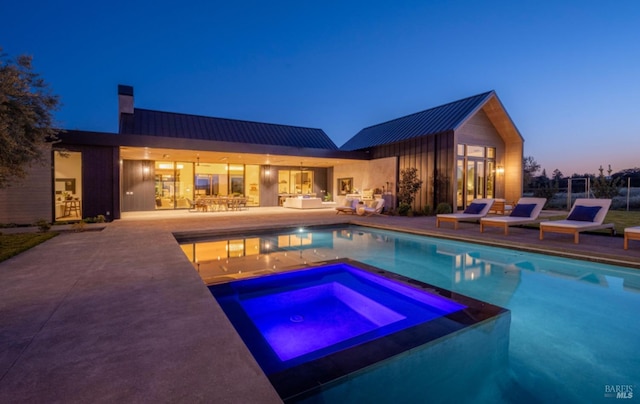 view of pool with an outdoor hangout area, a pool with connected hot tub, and a patio area