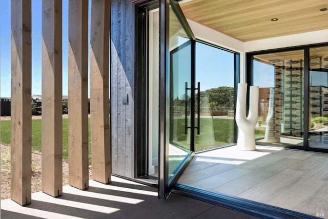 doorway to outside with wooden ceiling